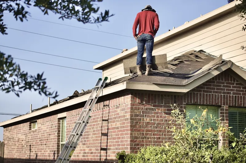 Professional roofer working on a residential roof in Stoopville